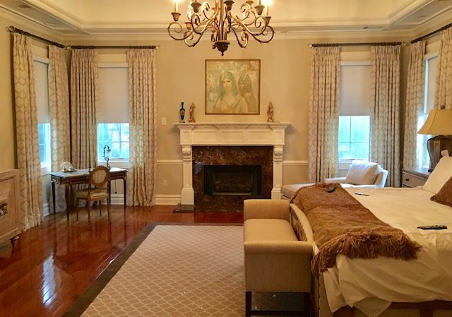 Pinch Pleat Drapes on Rods with Crystal Finials in Master Bedroom