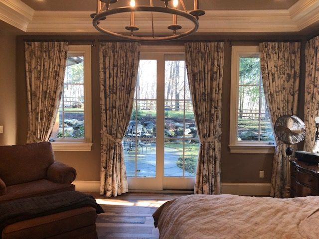 Pinch Pleat Drapes with Tie Backs in Master Bedroom