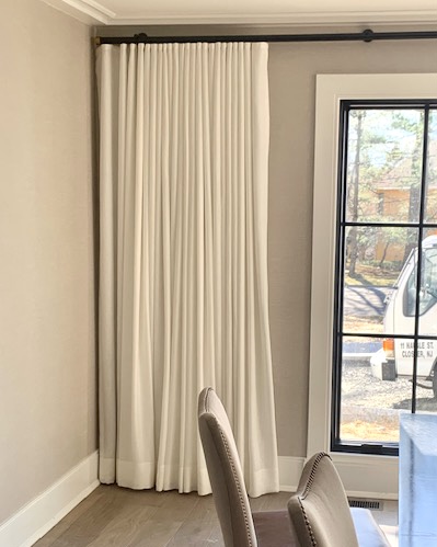 Ripple Fold Drapes on Black TRAX Hardware with Gold End Caps in Dining Room