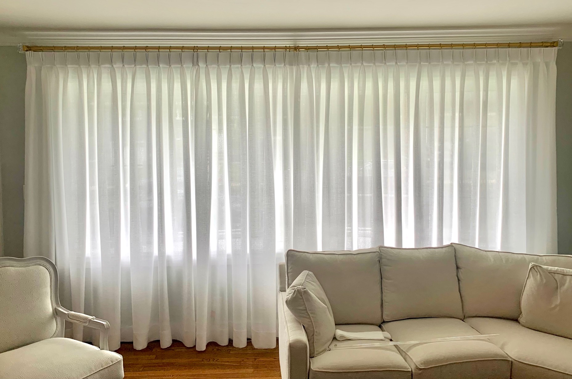 Wall of Linen Pinch Pleat Drapes on Gold TRAX Rod